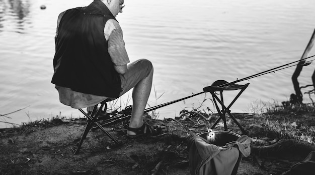 Free photo senior man fishing by a lake