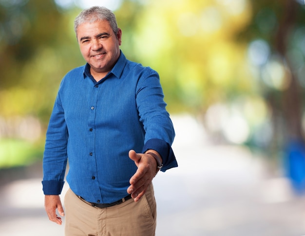 Senior man offering his hand