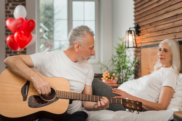 Senior man serenading wife on valentines day