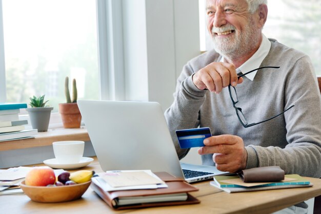 Senior man shopping online with a credit card