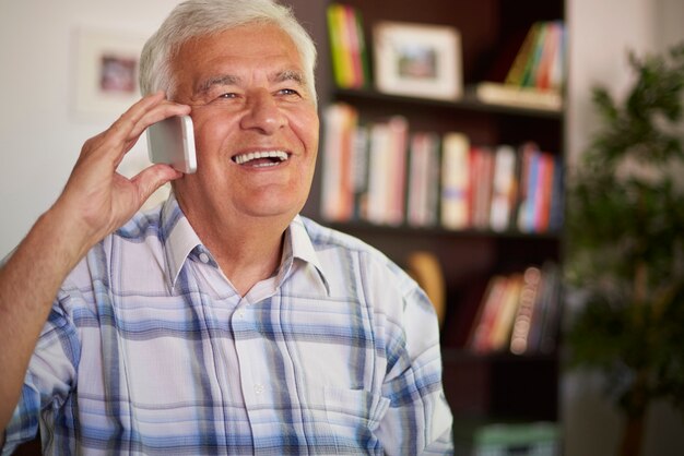 Senior man using his mobile telephone