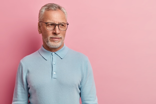 Senior man wearing blue shirt and glasses