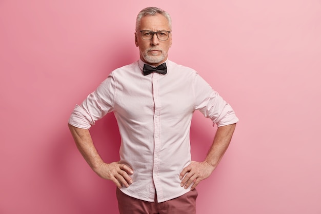 Free Photo senior man wearing white shirt and black bowtie