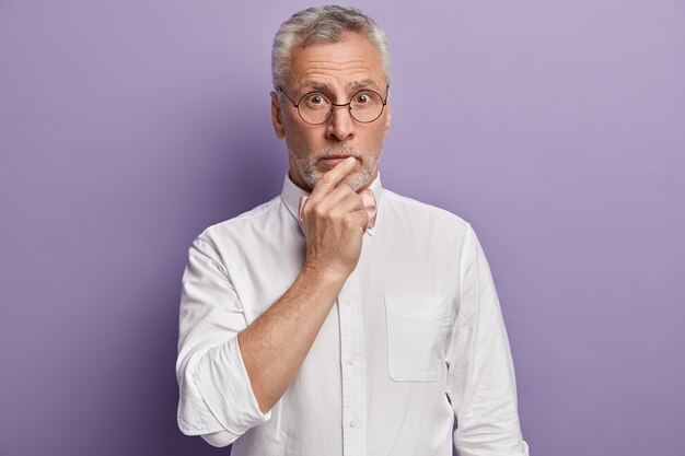 Senior man in white shirt and pink bowtie