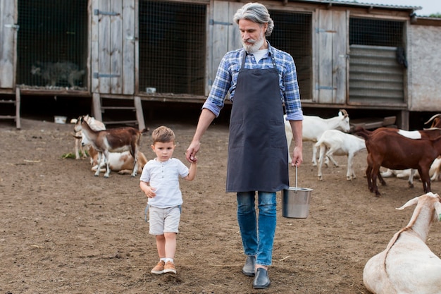 Free Photo senior man with grandson at country side