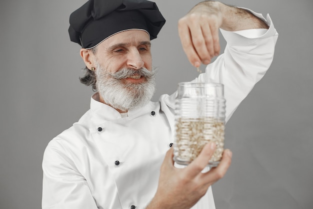 Free photo senior man with jar of oatmeal.