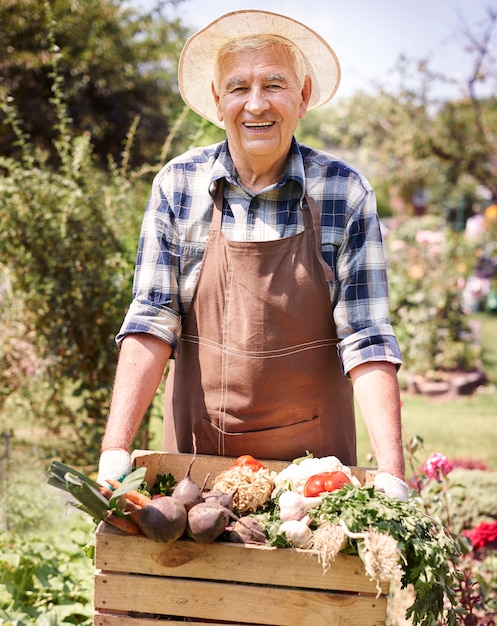 Senior man working in the field with flowers