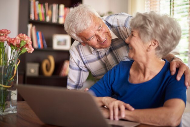 Senior marriage spending time in front of computer