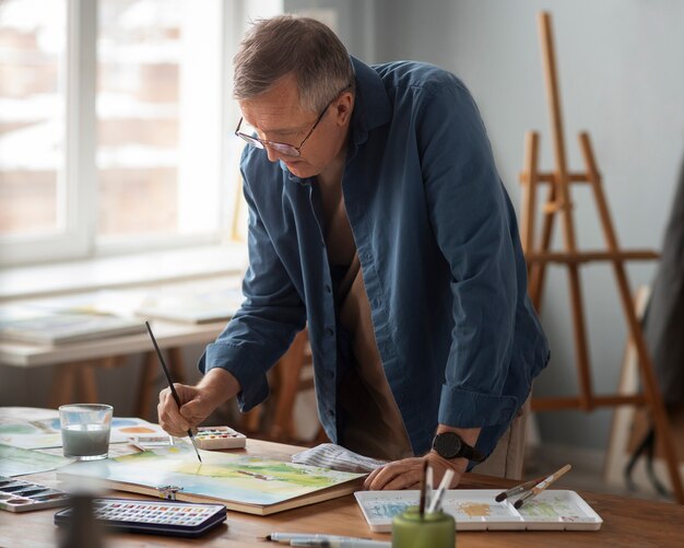 Senior painter using watercolor for his art