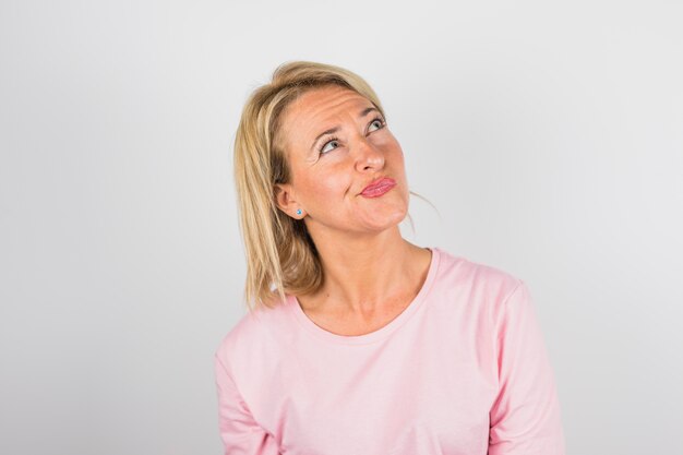 Senior pensive woman in rose blouse