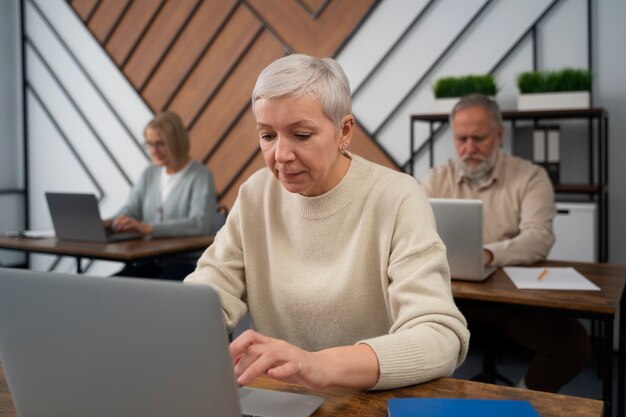 Senior people in school during class with laptop computer