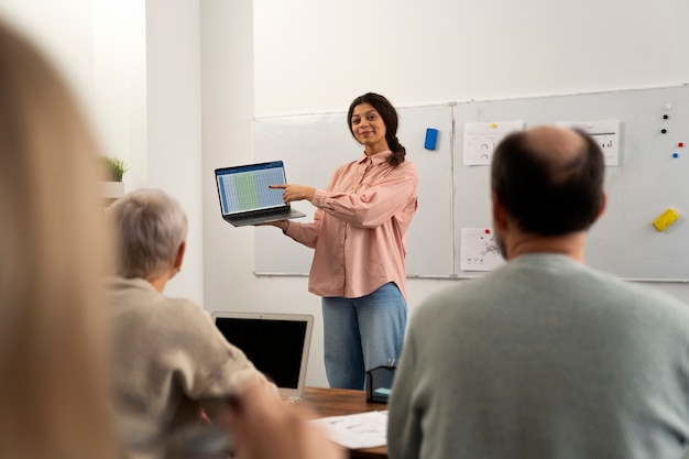 Senior people in school during class with laptop computer