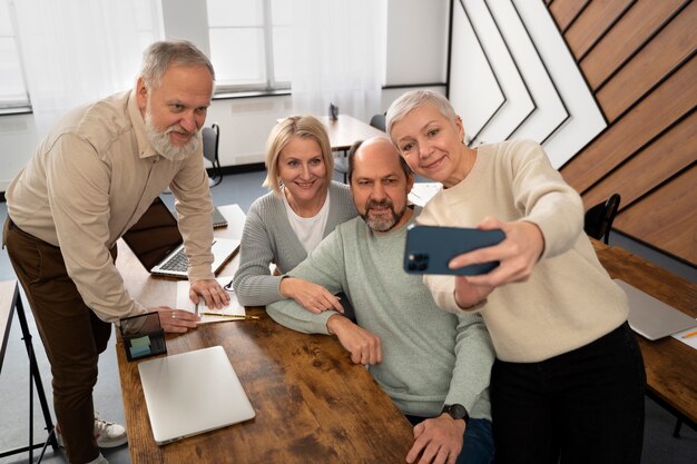 Senior people in school taking a selfie with smartphone