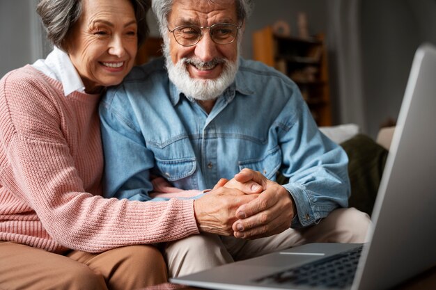 Senior people with laptop medium shot