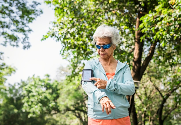 Senior runner using a fitness tracker