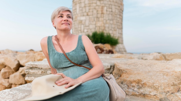 Senior tourist woman with beach hat