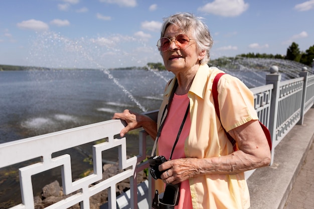 Free Photo senior traveler holding a camera