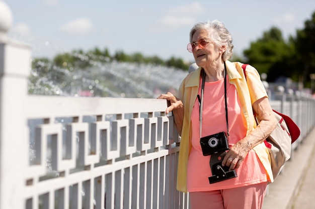 Free Photo senior traveler holding a camera