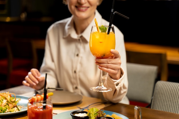 Senior woman drinking at a restaurant