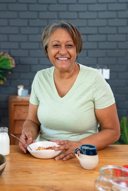 Senior woman eating front view