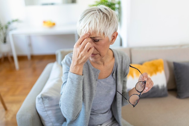 Free Photo senior woman in glasses rubs her eyes suffering from tired eyes ocular diseases concept