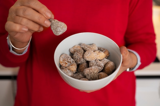 Free Photo senior woman having fig fruits at home