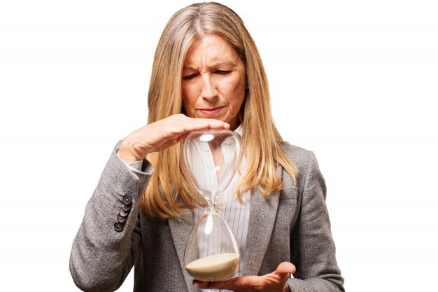 Senior woman holding an hourglass