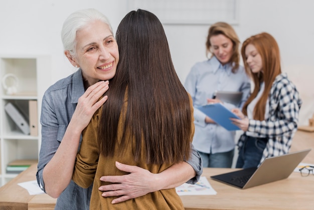 Senior woman hugging her friend