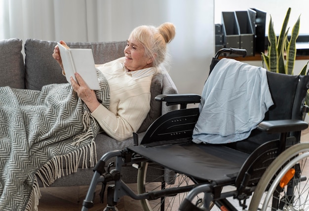 Senior woman lying in bed next to a wheelchair