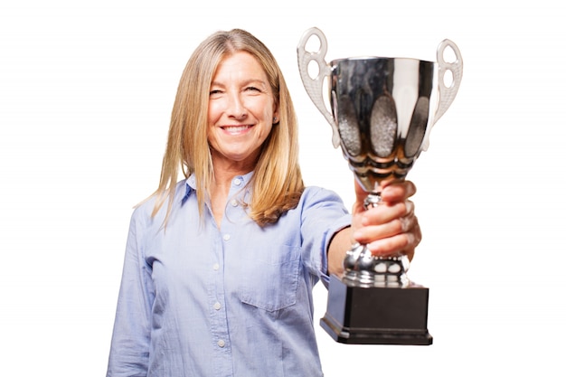 Free photo senior woman smiling with a trophy