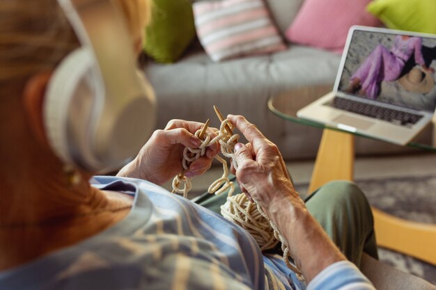 Senior woman studying at home getting online courses