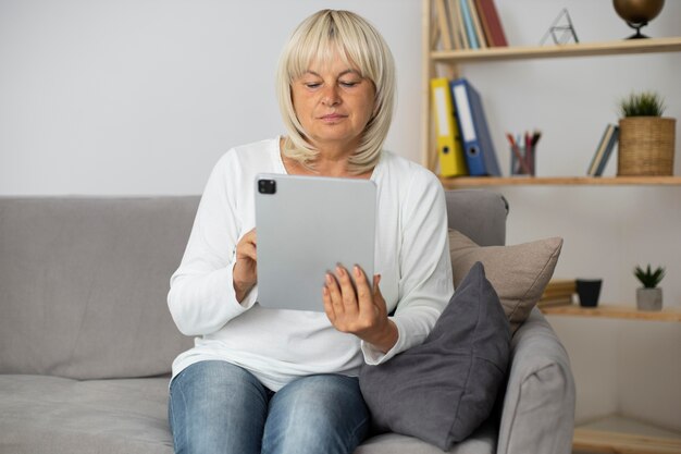 Senior woman taking an online class on her tablet