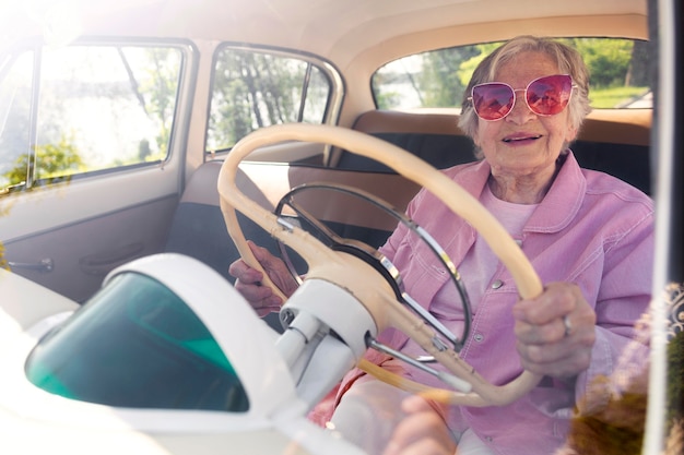 Senior woman traveling alone by car