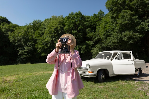 Free photo senior woman traveling alone and having fun