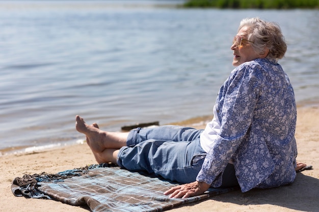 Free photo senior woman traveling alone in the summer