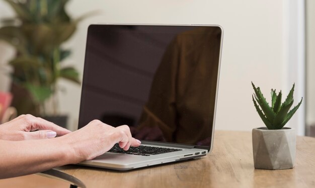 Senior woman using a laptop close-up