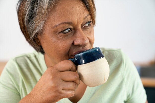 Senior woman with coffee cup front view