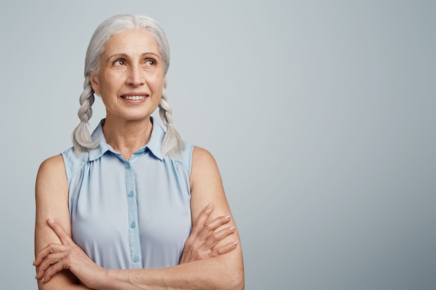 Free photo senior woman with pigtails dressed in blue blouse