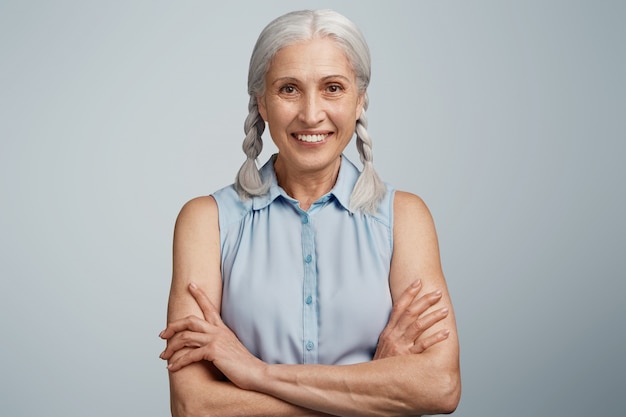 Senior woman with pigtails dressed in blue blouse