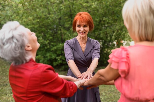 Senior women celebrating friendship in the park