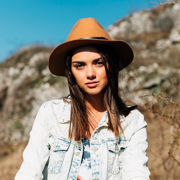 Sensual adult female in hat in nature