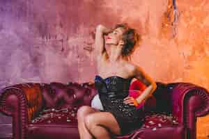 Free photo sensual woman on couch with confetti