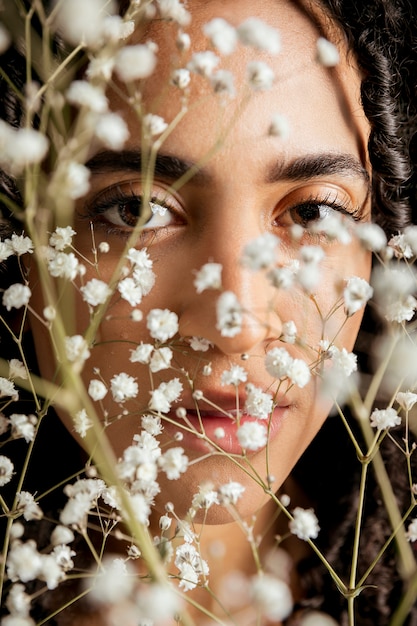 Free Photo sensual woman behind flower twigs 