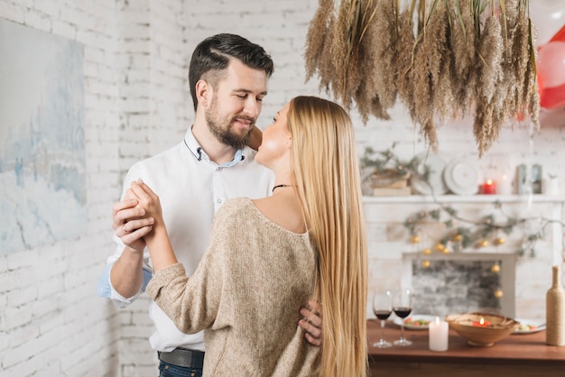 Sensual young couple dancing at home