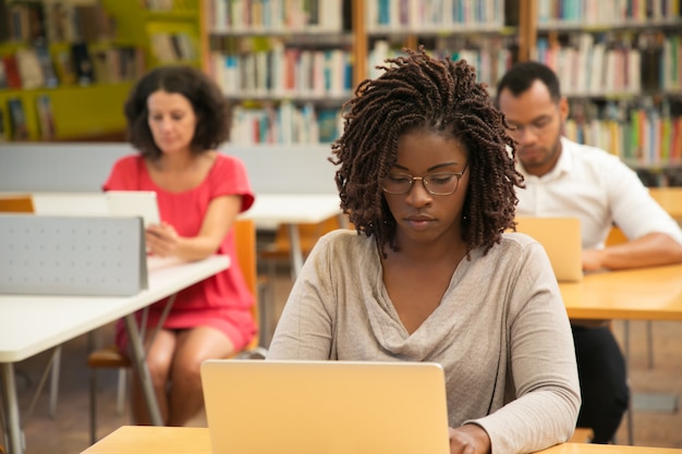 Serious African American student studying in library