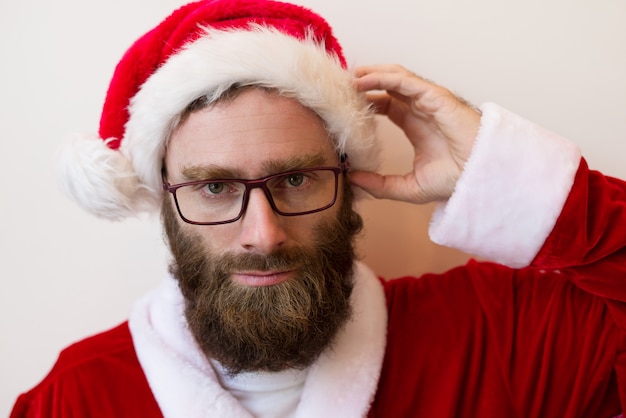 Free Photo serious bearded man wearing santa claus costume and glasses