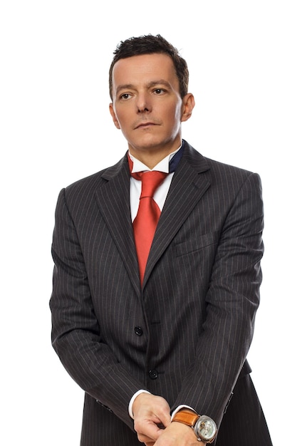 Serious business man in a suit and red tie. Isolated on white background.