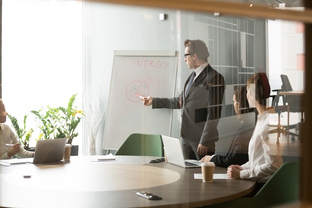 Free Photo serious businessman presenting company business goals to colleagues