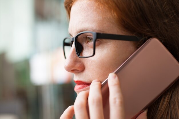 Serious businesswoman talking on mobile phone