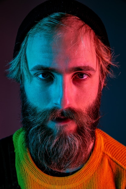 Free photo serious, close up. caucasian man's portrait on gradient  space in neon light